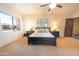 Bright bedroom with a large bed, nightstands, and carpeted floor at 15405 E Cavedale Dr, Scottsdale, AZ 85262