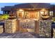 Stunning desert home with wrought iron gate and beautiful landscaping at 15405 E Cavedale Dr, Scottsdale, AZ 85262