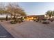 Front yard of desert home with gravel driveway and landscaping at 15405 E Cavedale Dr, Scottsdale, AZ 85262
