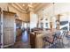 Open concept kitchen with island, granite countertops and wood cabinets at 15405 E Cavedale Dr, Scottsdale, AZ 85262