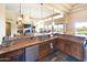 Open kitchen with granite island, stainless steel appliances, and wood cabinets at 15405 E Cavedale Dr, Scottsdale, AZ 85262