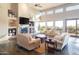 Spacious living room with high ceilings, fireplace, and large windows at 15405 E Cavedale Dr, Scottsdale, AZ 85262