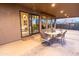 Covered patio features an outdoor dining area and backyard access at 15405 E Cavedale Dr, Scottsdale, AZ 85262