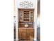 Built-in wooden wine cellar with glass doors and ample storage at 15405 E Cavedale Dr, Scottsdale, AZ 85262