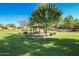 Community park with shaded picnic tables and grassy areas at 15949 N Cristine Ln, Surprise, AZ 85388