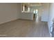 Bright and spacious living area with wood-look tile floors at 17065 W Seldon Ln, Waddell, AZ 85355