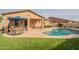 Stunning kidney shaped pool with patio furniture and covered patio at 2025 W Desert Spring Way, San Tan Valley, AZ 85144