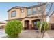 Two-story house with tan exterior, brown accents, and a two-car garage at 2091 W Garland Dr, San Tan Valley, AZ 85144