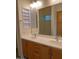 Double vanity bathroom with modern light fixtures and a large mirror at 21039 E Poco Calle St, Queen Creek, AZ 85142