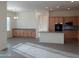 Open concept kitchen and dining area with light wood cabinets at 21039 E Poco Calle St, Queen Creek, AZ 85142