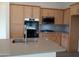 Modern kitchen with light wood cabinets and gray countertops at 21039 E Poco Calle St, Queen Creek, AZ 85142
