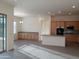 Open concept kitchen and dining area with light wood cabinets at 21039 E Poco Calle St, Queen Creek, AZ 85142
