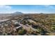 Aerial view of a desert property with a large house, stables, and riding arena at 26639 N 132Nd St, Scottsdale, AZ 85262
