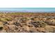 Aerial view of a desert landscape with a dirt road leading through the natural terrain at 26639 N 132Nd St, Scottsdale, AZ 85262