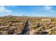 Aerial view of a desert landscape with a long dirt road and distant mountains at 26639 N 132Nd St, Scottsdale, AZ 85262