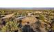 Aerial view of a ranch property with horse corral and covered shelters at 26639 N 132Nd St, Scottsdale, AZ 85262