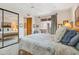 Bedroom with wooden bed frame and access to a private balcony at 26639 N 132Nd St, Scottsdale, AZ 85262