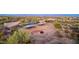 Aerial view of two adjacent corrals with covered shelters at 26639 N 132Nd St, Scottsdale, AZ 85262