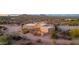 Aerial view of a stucco home with a large driveway and desert landscaping at 26639 N 132Nd St, Scottsdale, AZ 85262
