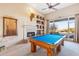 Game room features a pool table, fireplace, and built-in shelving at 26639 N 132Nd St, Scottsdale, AZ 85262