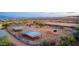 Aerial view of horse stables with covered areas and a riding arena at 26639 N 132Nd St, Scottsdale, AZ 85262