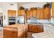 Spacious kitchen with island, wood cabinets, and stainless steel appliances at 26639 N 132Nd St, Scottsdale, AZ 85262
