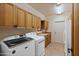 Laundry room with wooden cabinets and modern appliances at 26639 N 132Nd St, Scottsdale, AZ 85262