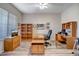 Spacious home office with built-in shelving and wood desk at 3041 W Keller Dr, Anthem, AZ 85086