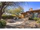 Landscaped backyard oasis with fire pit, built-in grill, and seating area at 32051 N 73Rd Pl, Scottsdale, AZ 85266
