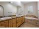 Elegant bathroom with double vanity, soaking tub, and tile flooring at 32051 N 73Rd Pl, Scottsdale, AZ 85266
