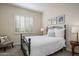 Cozy bedroom with metal bed frame and window with shutters at 32051 N 73Rd Pl, Scottsdale, AZ 85266