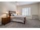 Bright bedroom with double bed, nightstands, and window with shutters at 32051 N 73Rd Pl, Scottsdale, AZ 85266