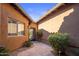 Stone pathway leads to private courtyard with wrought iron gate and lush landscaping at 32051 N 73Rd Pl, Scottsdale, AZ 85266