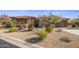 Single-story home with stucco and stone exterior, landscaped yard, and two-car garage at 32051 N 73Rd Pl, Scottsdale, AZ 85266