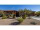 Single-story home with stucco and stone exterior, landscaped yard, and two-car garage at 32051 N 73Rd Pl, Scottsdale, AZ 85266