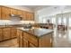 Open concept kitchen with granite island, stainless steel appliances, and wood cabinets at 32051 N 73Rd Pl, Scottsdale, AZ 85266