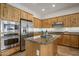 Modern kitchen with stainless steel appliances and wood cabinets at 32051 N 73Rd Pl, Scottsdale, AZ 85266
