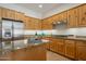 Kitchen features granite countertops, stainless steel appliances, and wood cabinets at 32051 N 73Rd Pl, Scottsdale, AZ 85266