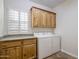 Laundry room with wood cabinets and washer/dryer hookups at 32051 N 73Rd Pl, Scottsdale, AZ 85266