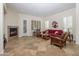 Living room with fireplace, red couch, and wood armchairs at 32051 N 73Rd Pl, Scottsdale, AZ 85266