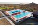 Community pool with multiple lounge chairs and umbrellas at 32962 N 131St Dr, Peoria, AZ 85383