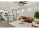 Open living room with a brown couch and kitchen island at 471 E Diamond Dr, Casa Grande, AZ 85122