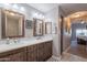 Double vanity bathroom with dark wood cabinets and white countertops at 5350 E Deer Valley Dr # 4433, Phoenix, AZ 85054