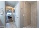 Bathroom with walk-in shower, tile flooring, and a view of bedroom at 5350 E Deer Valley Dr # 4433, Phoenix, AZ 85054