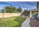 Landscaped backyard featuring a grassy area and patio with seating at 8428 E Meseto Cir, Mesa, AZ 85209