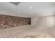 Spacious basement room with stone wall and carpet at 8611 E Cholla St, Scottsdale, AZ 85260