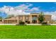House exterior showcasing stone facade and a large yard at 8611 E Cholla St, Scottsdale, AZ 85260
