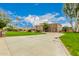 Exterior view of home with a long driveway and lush landscaping at 8611 E Cholla St, Scottsdale, AZ 85260