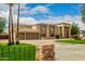 Impressive house exterior, showcasing stone accents and a manicured lawn at 8611 E Cholla St, Scottsdale, AZ 85260