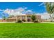 Two-story house with stone accents and a lush green lawn at 8611 E Cholla St, Scottsdale, AZ 85260